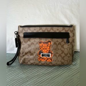 Coach Pouch Bag in Signature print with wrist strap